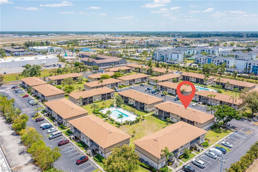 4790 South Cleveland Avenue, Unit 607 Fort Myers, FL 33907 - Photo 2 of 21 an aerial view of a building with an outdoor space and seating