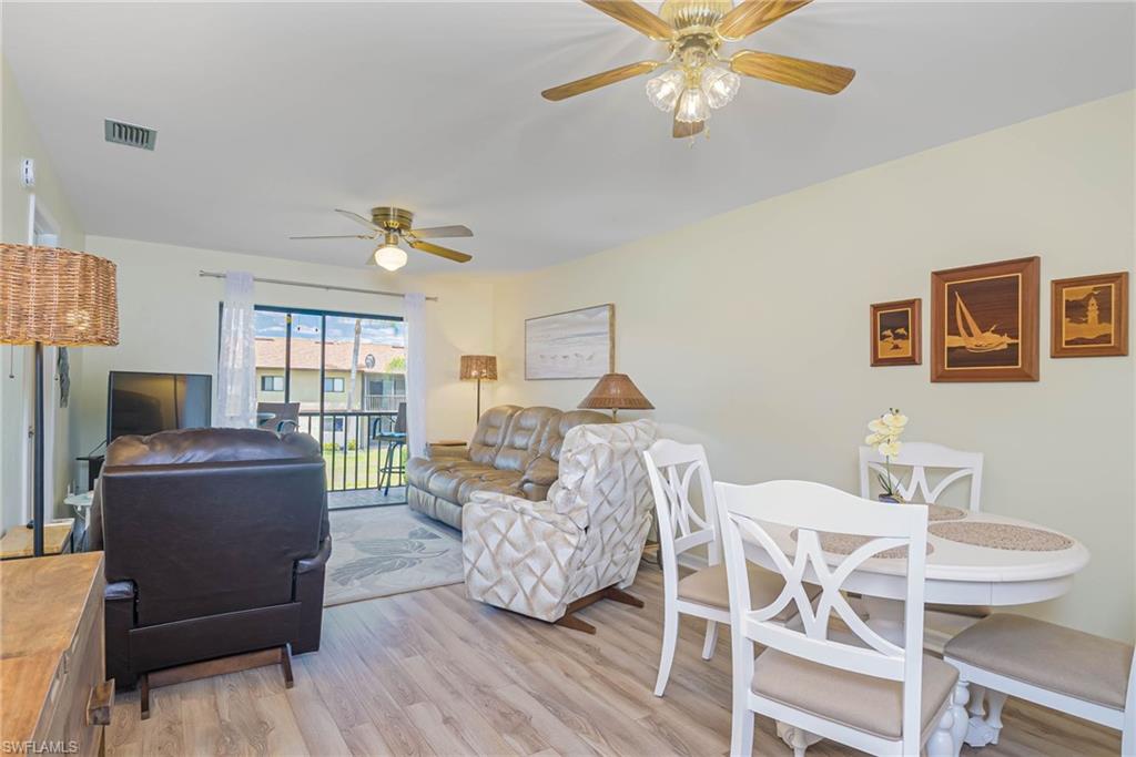 4790 South Cleveland Avenue, Unit 607 Fort Myers, FL 33907 - Photo 3 of 21 a living room with furniture and a wooden floor