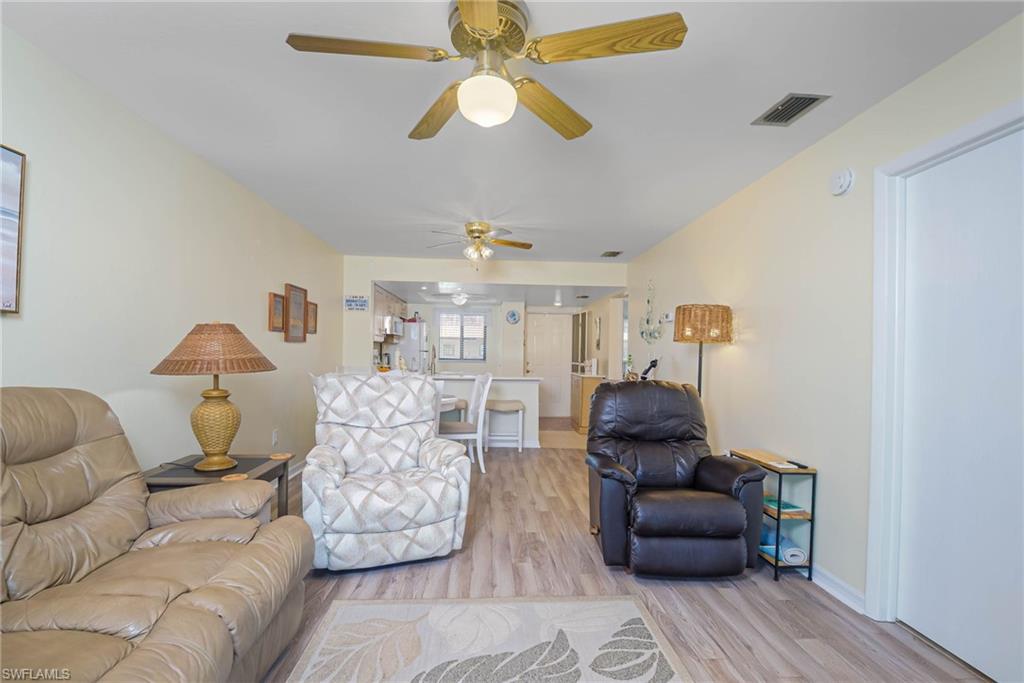 4790 South Cleveland Avenue, Unit 607 Fort Myers, FL 33907 - Photo 5 of 21 a living room with furniture and a chandelier