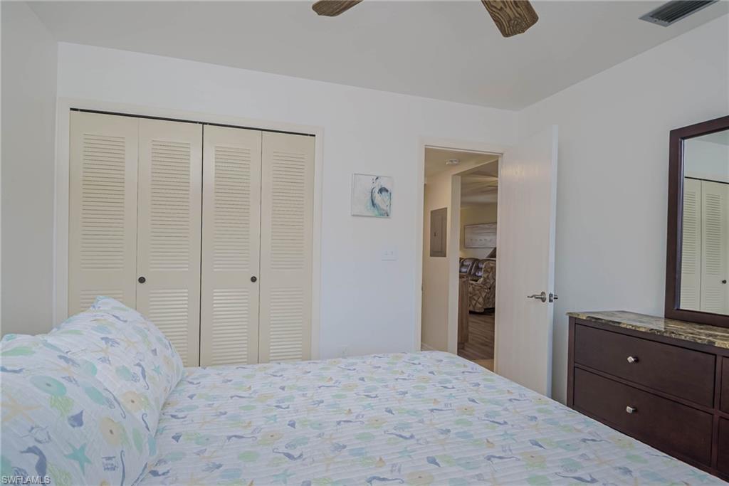 4790 South Cleveland Avenue, Unit 607 Fort Myers, FL 33907 - Photo 10 of 21 a bedroom with a bed and a mirror
