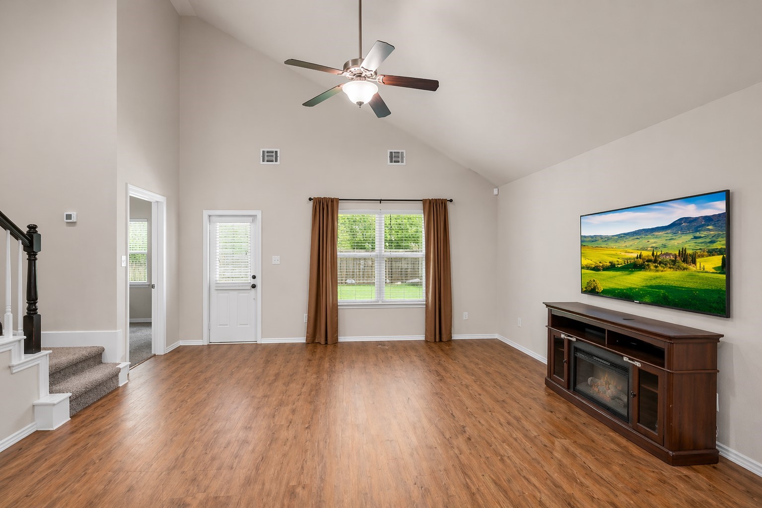 5635 Rainflower Terrace Lane Spring, TX 77389 - Photo 3 of 46 VAULTED ceilings and a stunning, unique staircase upstairs welcome you HOME.
(AI edited pic since furniture was removed after professional photographer came out!)