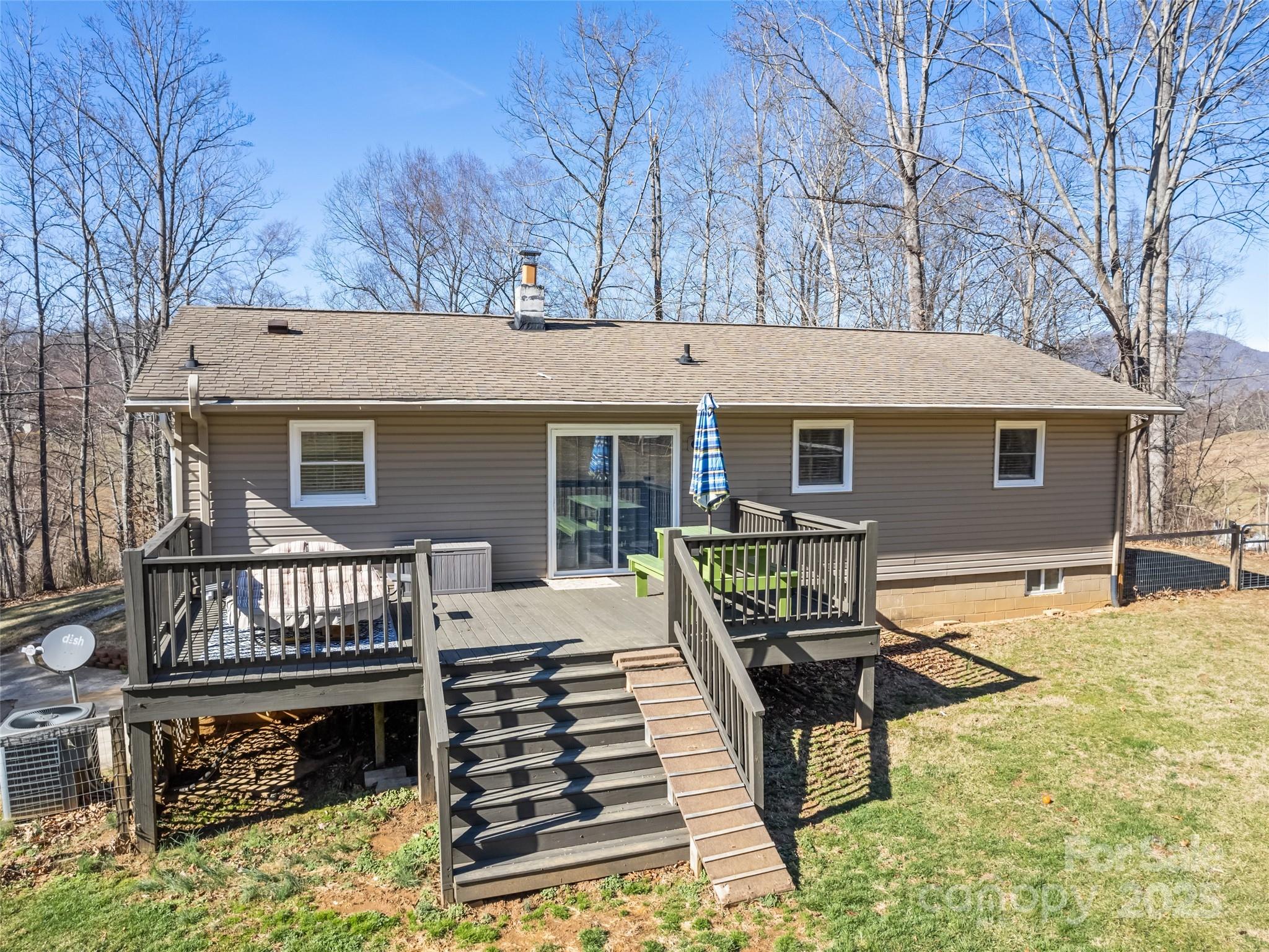 200 Stamey Cove Road Clyde, NC 28721 - Photo 5 of 36 a view of a house with wooden deck and furniture