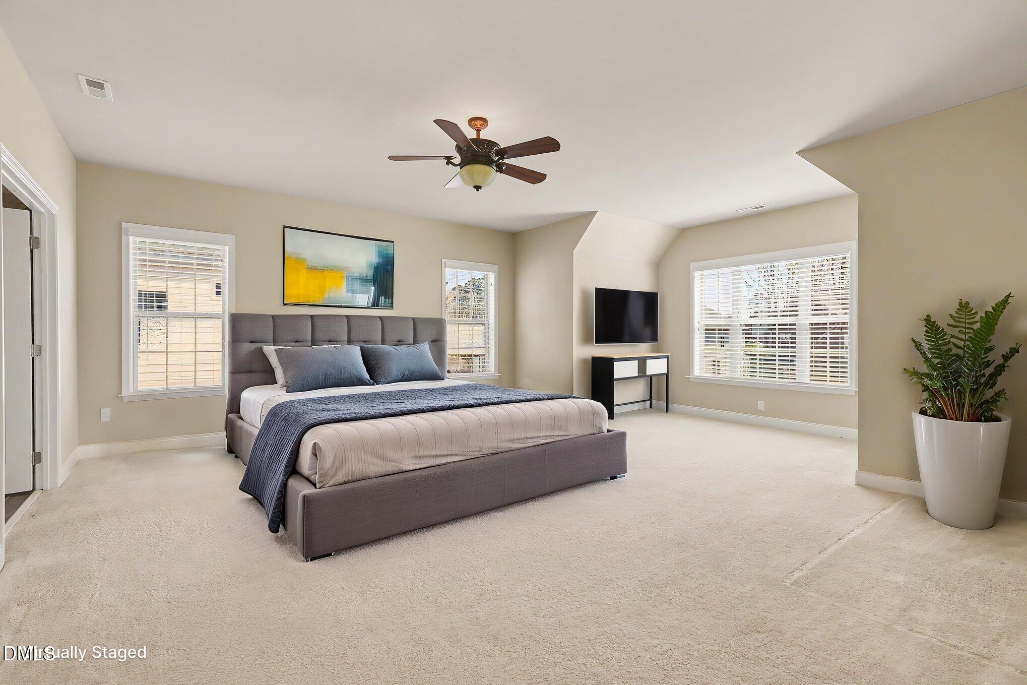 351 Gartrell Way Cary, NC 27519 - Photo 32 of 51 a spacious bedroom with a bed and a couch