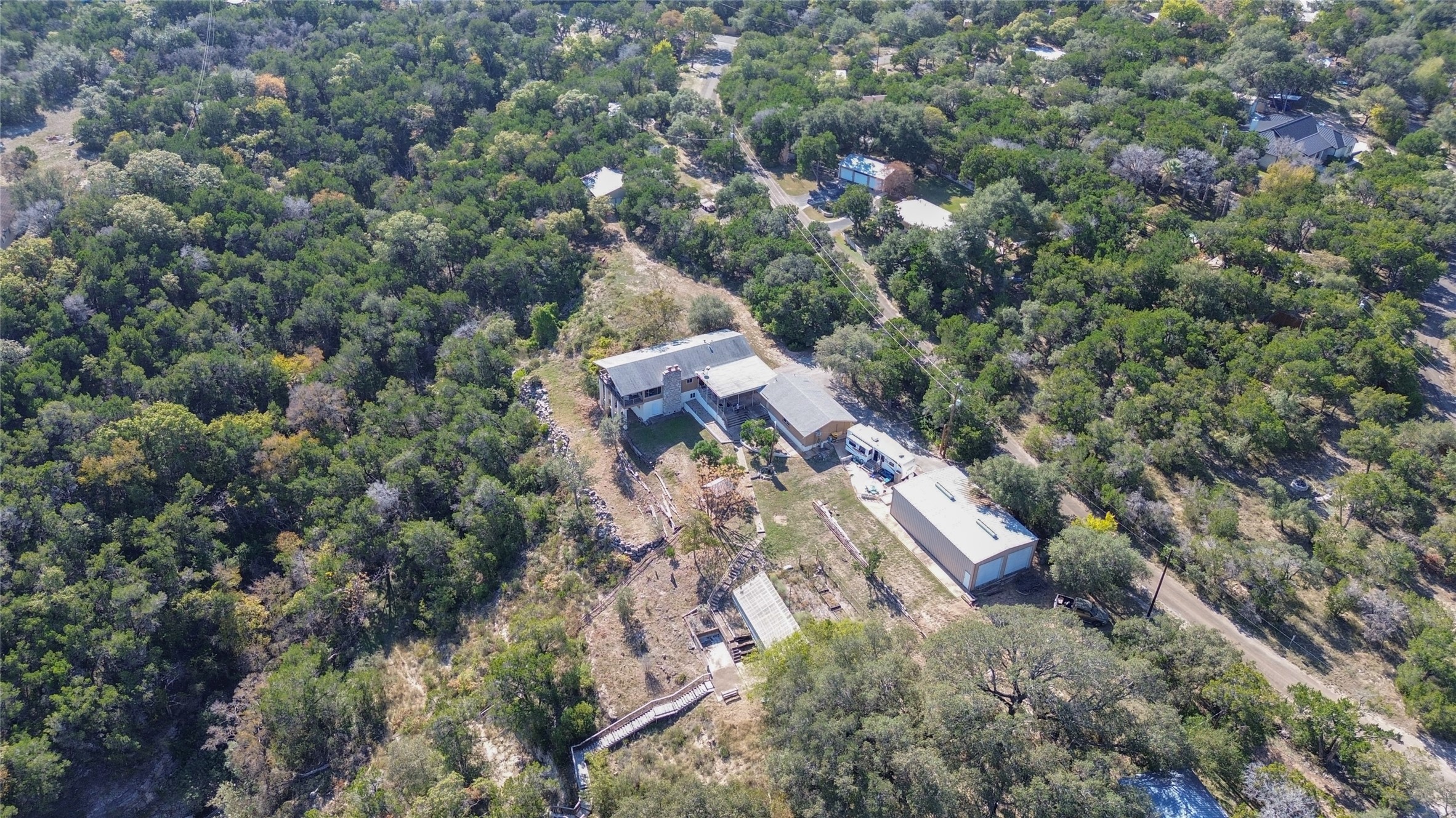 3807 Boat Dock Road Lago Vista, TX 78645 - Photo 2 of 37 Perched on a verdant hillside, this property offers serene, tree-dotted acreage and ample space for additional structures.