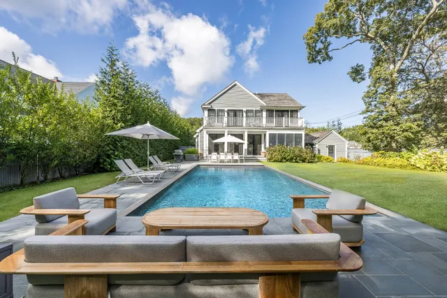a view of house with swimming pool outdoor seating
