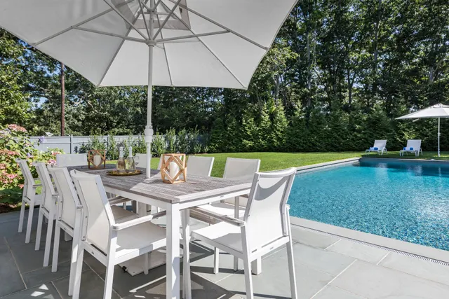 a patio with a yard table and chairs