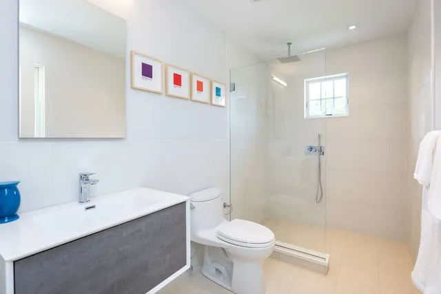 a white toilet sitting next to a bathroom sink