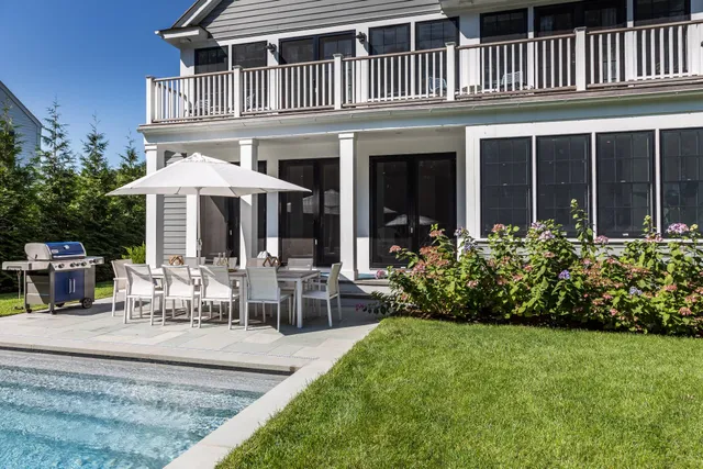 a view of a house with backyard porch and sitting area