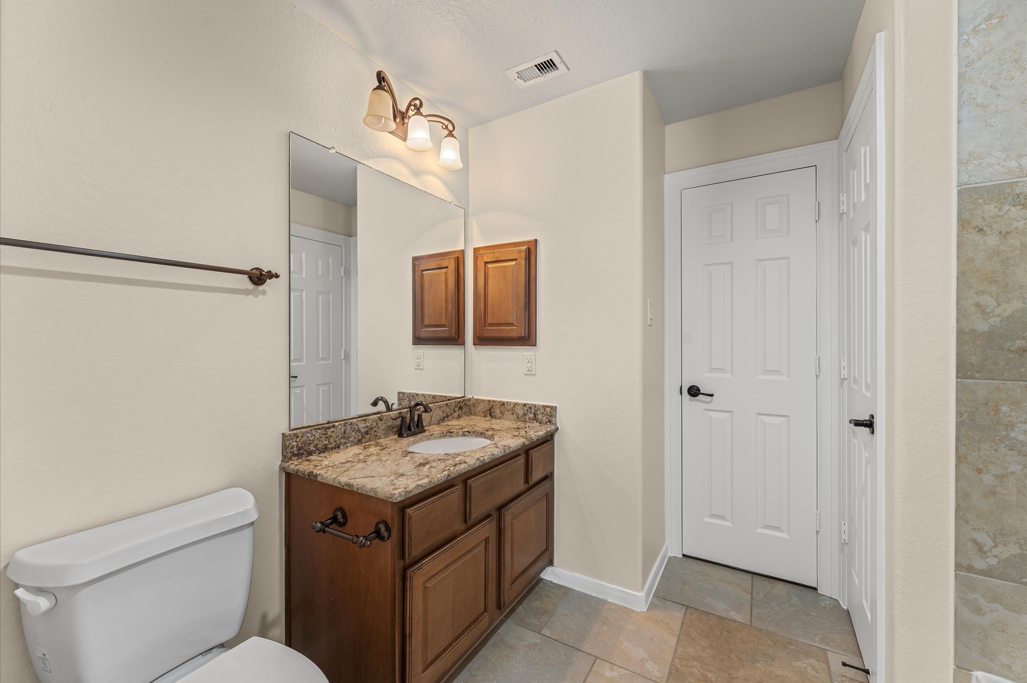 7 North Beech Springs Circle Spring, TX 77389 - Photo 42 of 50 a bathroom with a toilet sink and mirror
