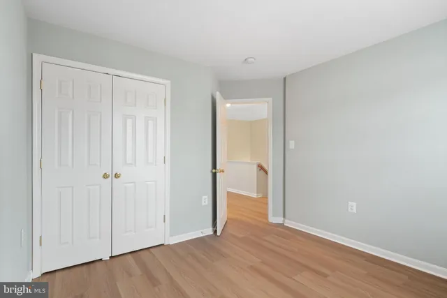 a view of an empty room and wooden floor