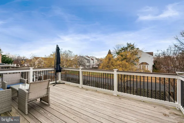 a view of balcony with wooden floor and fence