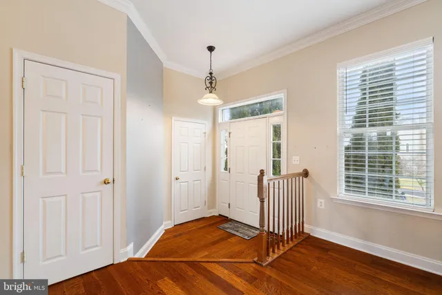 a view of a room with wooden floor and windows