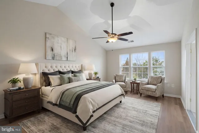 a spacious bedroom with a bed and a window