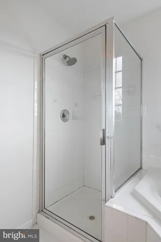 a bathroom with a glass shower door