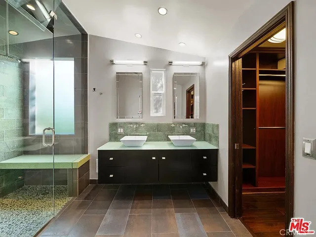 a bathroom with a tub sink and mirror