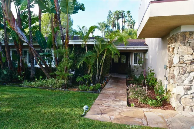 a front view of a house with a garden