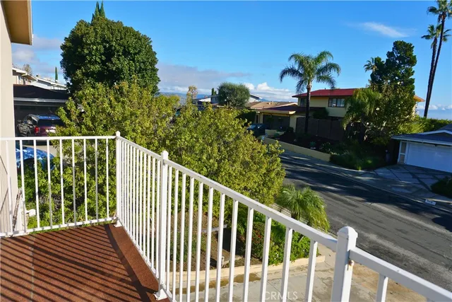a view of a balcony with flower plants