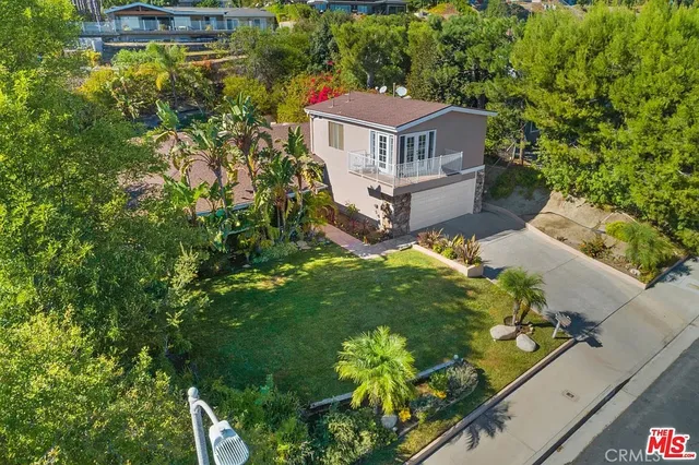 an aerial view of a house with a yard