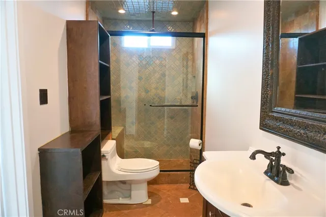 a bathroom with a toilet sink and shower