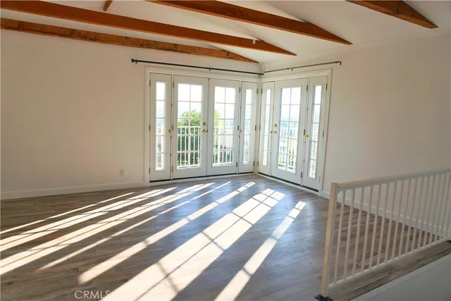 a view of a room with wooden floor and windows