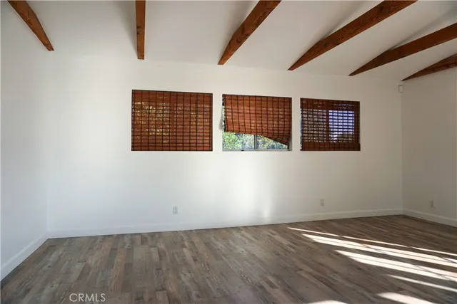 an empty room with wooden floor
