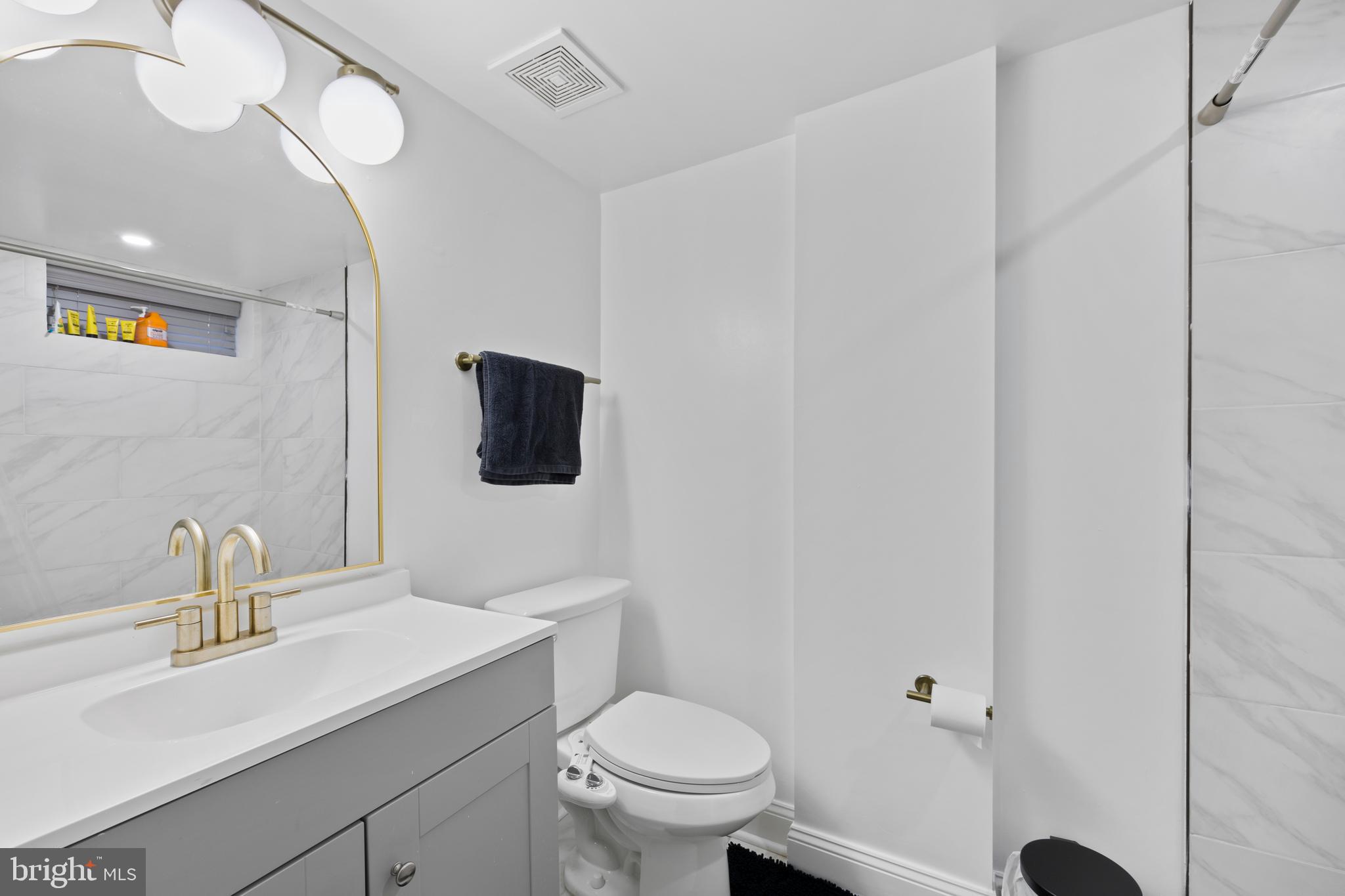 4511 Marble Hall Road Baltimore, MD 21239 - Photo 37 of 48 a bathroom with a toilet a sink and mirror