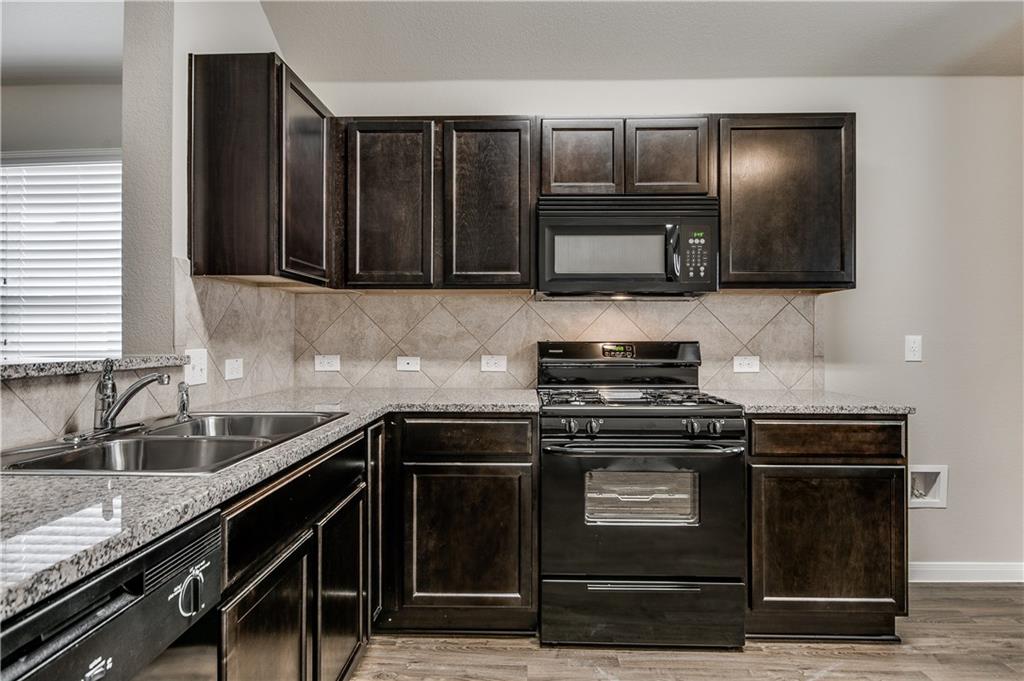 185 Voss Kyle, TX 78640 - Photo 2 of 26 a kitchen with granite countertop a stove and a sink