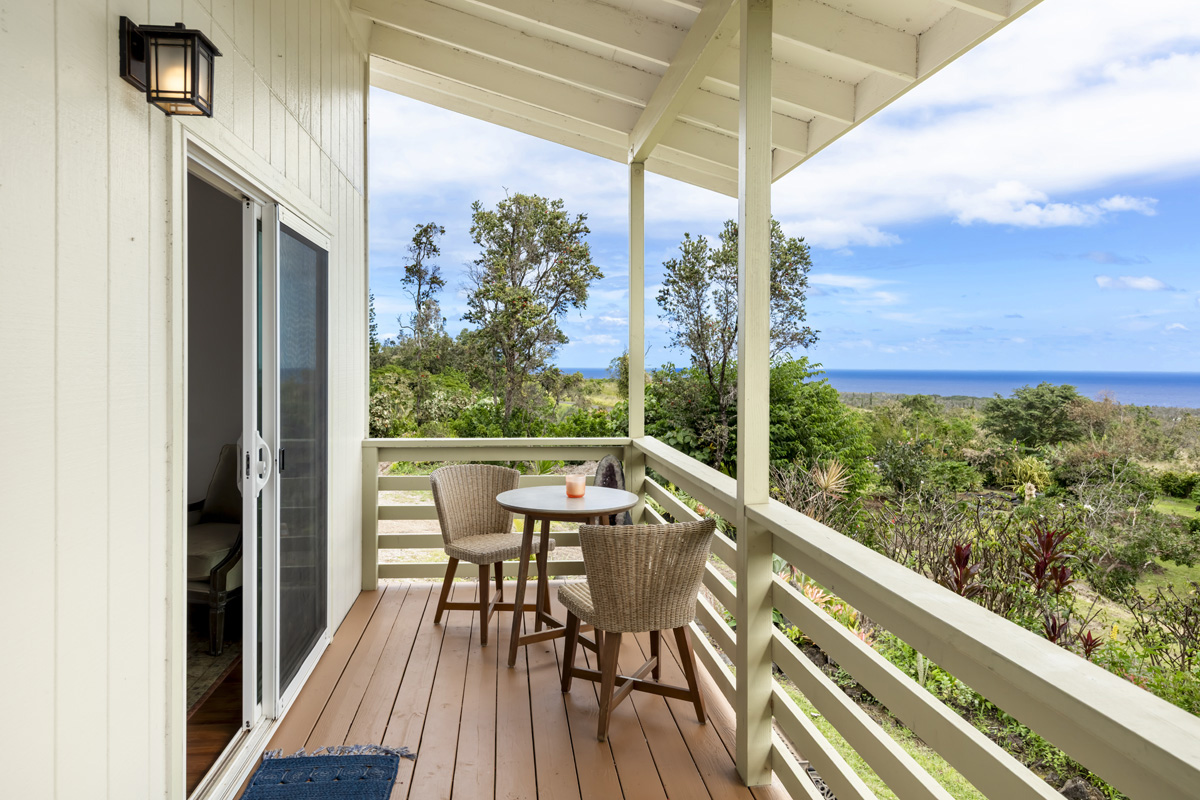 12-1098 Kaimu-Makena Homestead Road Pahoa, HI 96778 - Photo 13 of 29 a view of a balcony with chairs and wooden floor