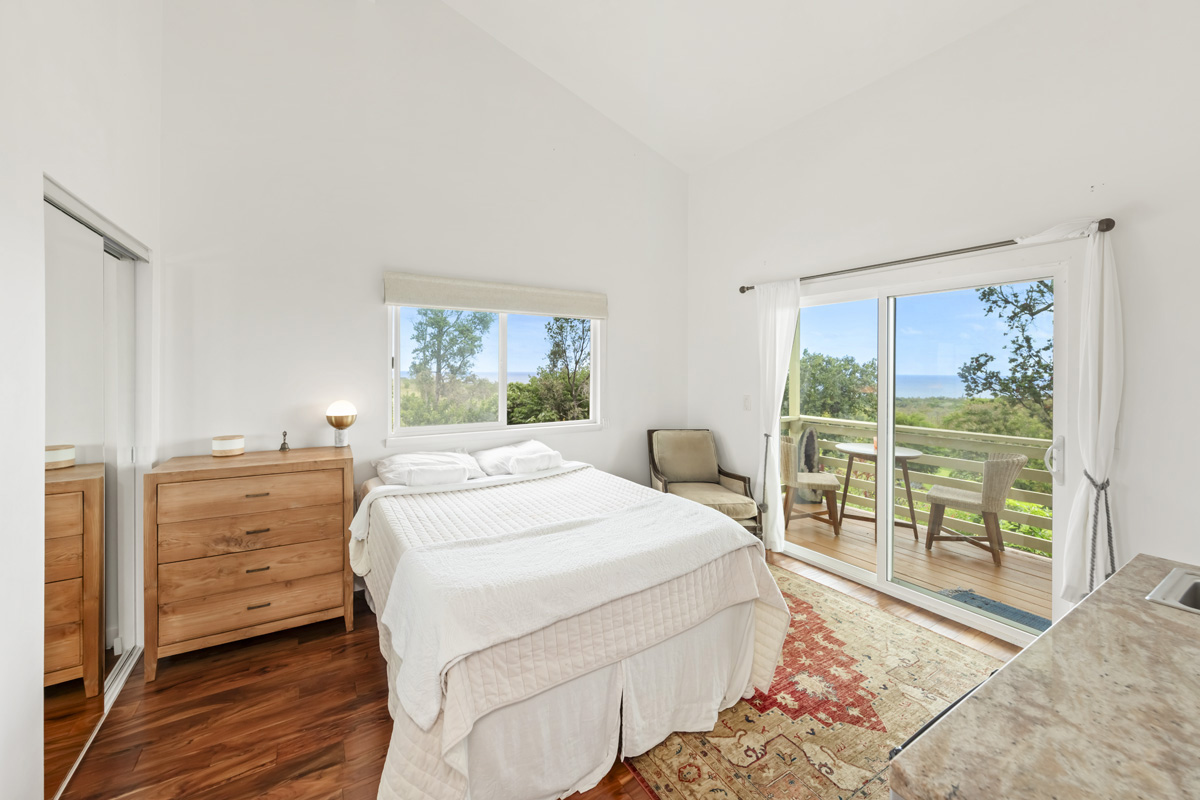 12-1098 Kaimu-Makena Homestead Road Pahoa, HI 96778 - Photo 19 of 29 a bedroom with a large bed and a large window