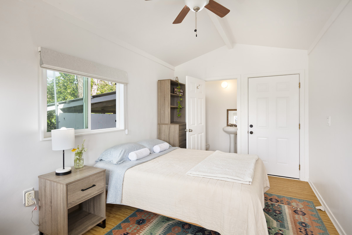 12-1098 Kaimu-Makena Homestead Road Pahoa, HI 96778 - Photo 25 of 29 a bedroom with a bed and a table
