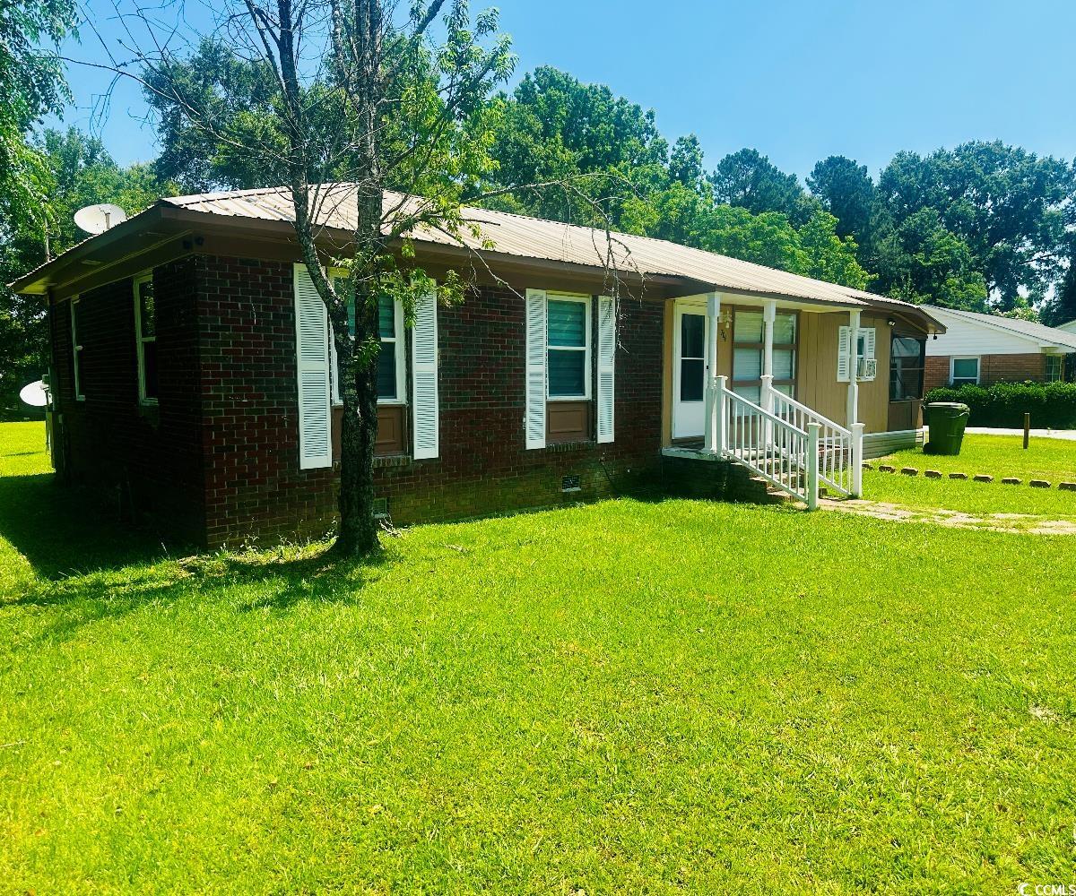 704 West Alder Street Andrews, SC 29510 - Photo 2 of 12 View of front of property featuring brick siding, a front yard, and a porch