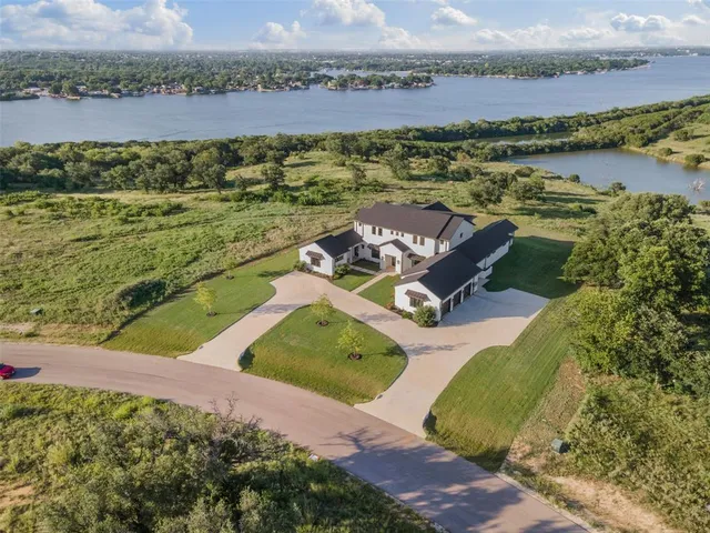 an aerial view of a house with a lake view
