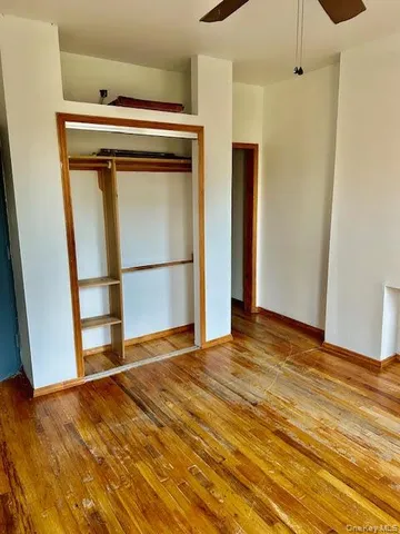 a view of a room with wooden floor and cabinet