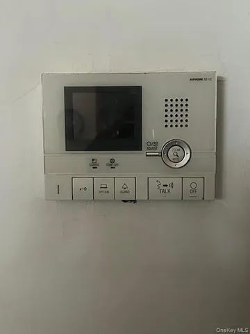 a view of livingroom with stainless steel appliances wooden floor