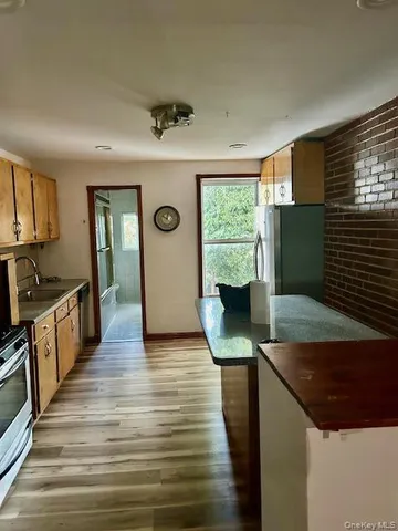a kitchen with sink and refrigerator