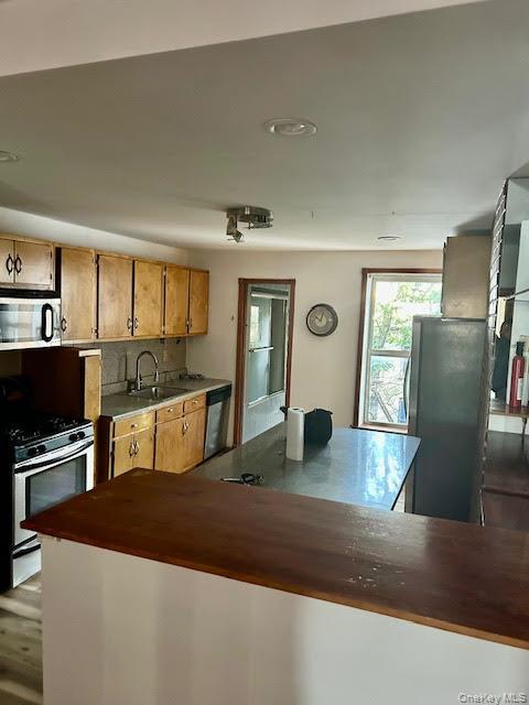 575 Warren Street, Unit 4R Brooklyn, NY 11217 - Photo 5 of 13 a kitchen with stainless steel appliances granite countertop a refrigerator a stove and a sink with wooden floor