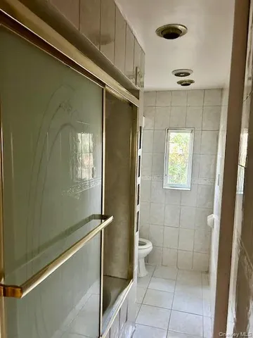 a bathroom with a glass door shower