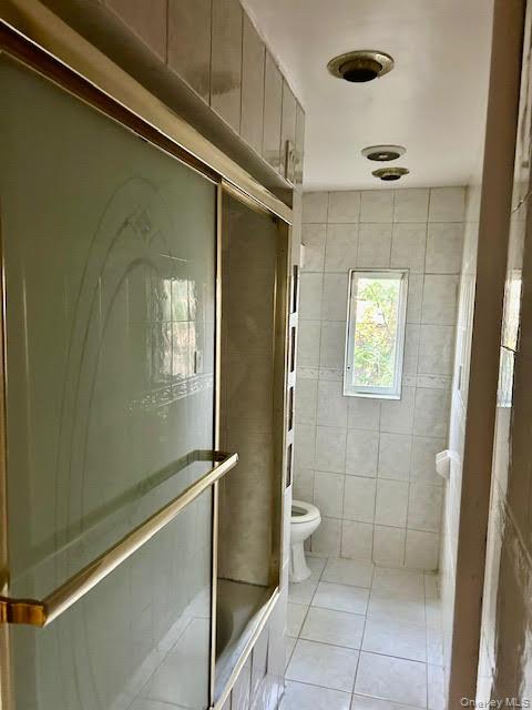 575 Warren Street, Unit 4R Brooklyn, NY 11217 - Photo 7 of 13 a bathroom with a glass door shower