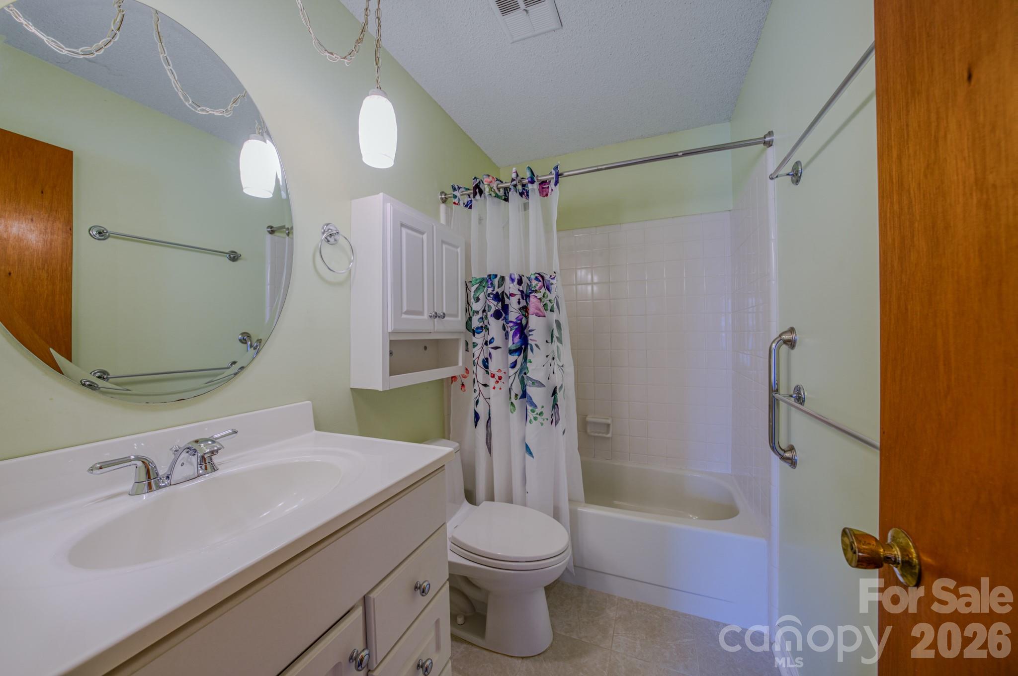 31 Knoll Ridge Drive Asheville, NC 28804 - Photo 16 of 30 a bathroom with a sink vanity mirror bathtub and toilet