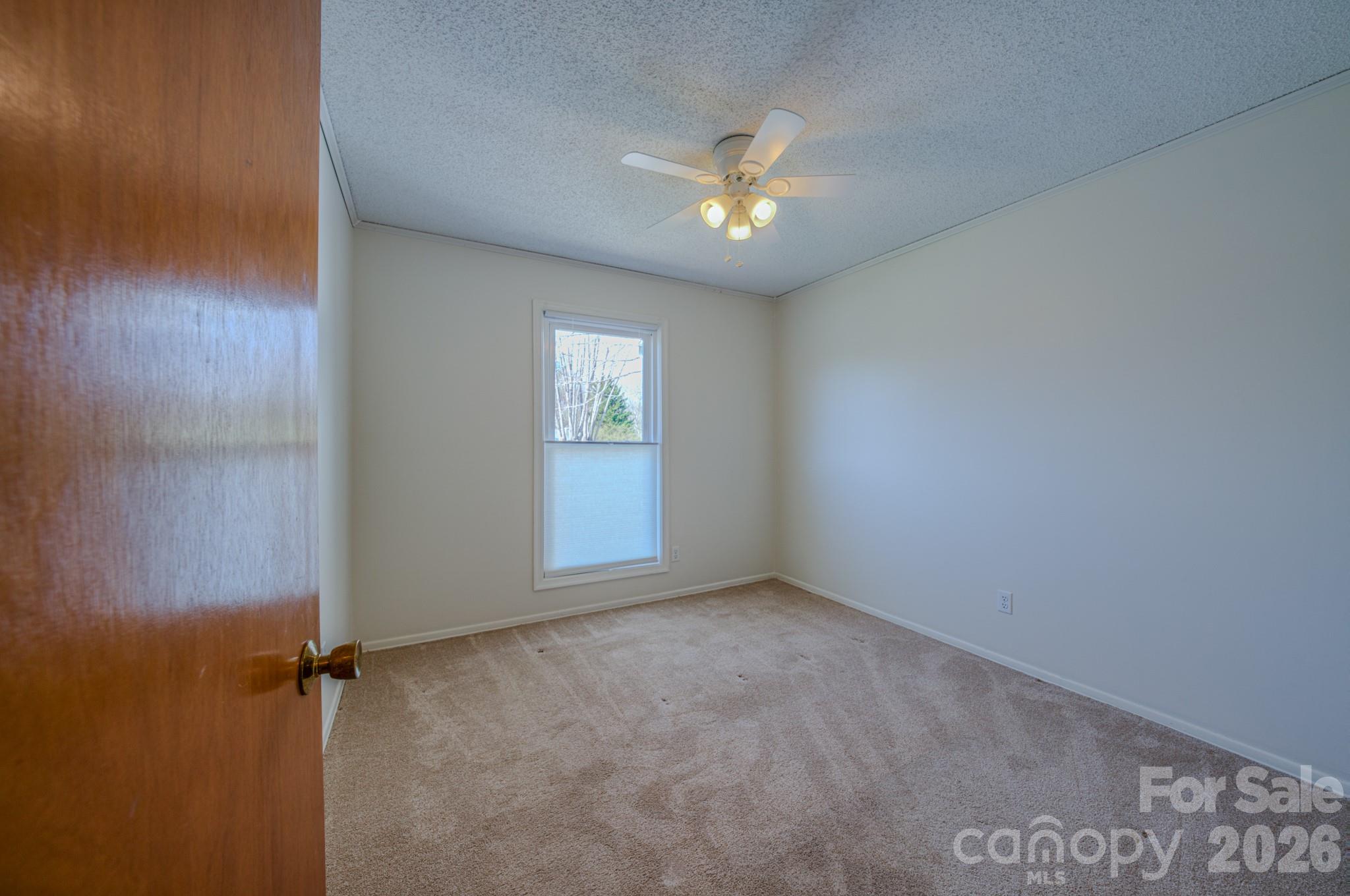 31 Knoll Ridge Drive Asheville, NC 28804 - Photo 17 of 30 an empty room with windows and fan