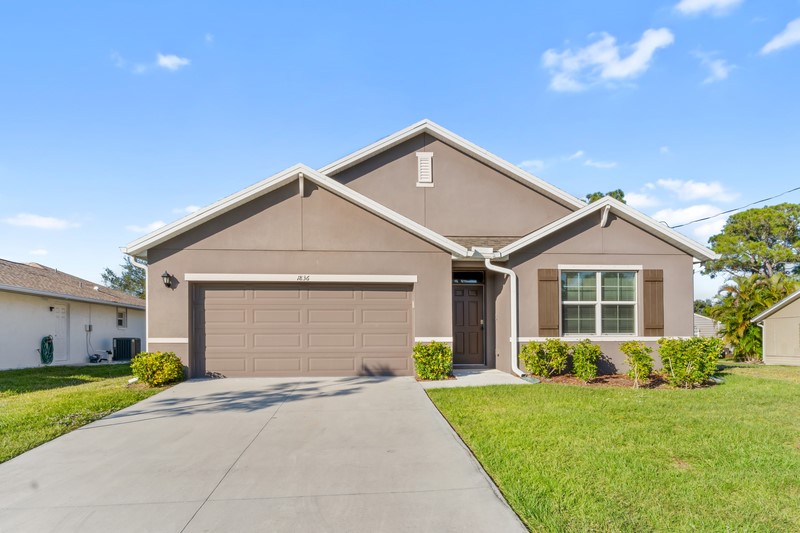 a front view of house with yard and green space