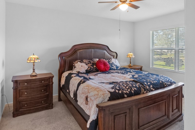 1836 Barber Street Sebastian, FL 32958 - Photo 11 of 29 a bedroom with a bed and a chandelier