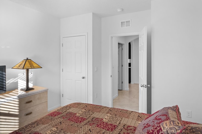 1836 Barber Street Sebastian, FL 32958 - Photo 15 of 29 a bedroom with a bed and a lamp on dresser