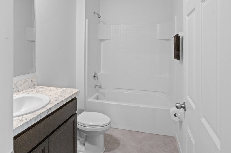 1836 Barber Street Sebastian, FL 32958 - Photo 17 of 29 a bathroom with a granite countertop sink toilet and shower