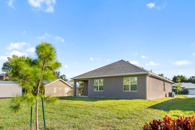 1836 Barber Street Sebastian, FL 32958 - Photo 26 of 29 a house that is sitting in the grass with large trees