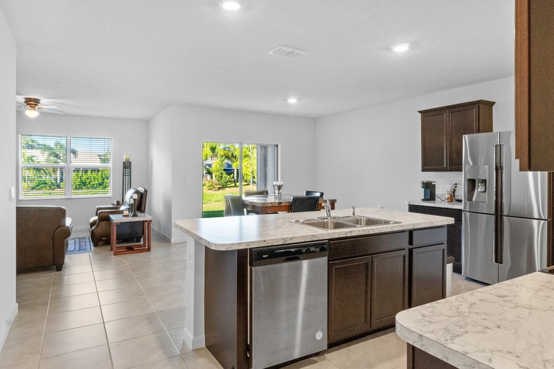 1836 Barber Street Sebastian, FL 32958 - Photo 7 of 29 a kitchen with a sink a counter top space and stainless steel appliances