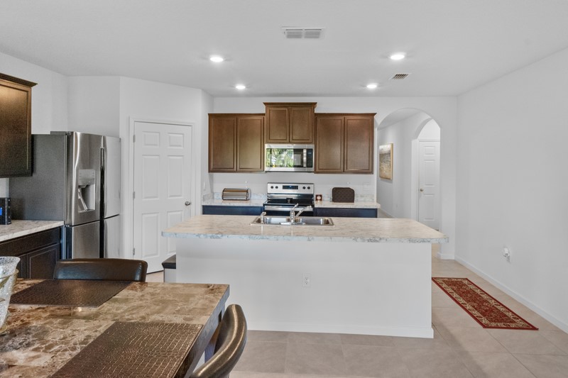 1836 Barber Street Sebastian, FL 32958 - Photo 8 of 29 a kitchen with stainless steel appliances granite countertop a sink refrigerator and microwave