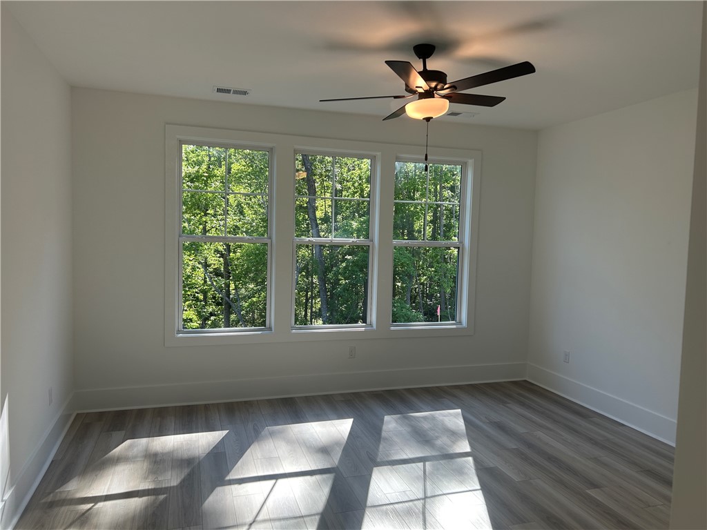 131 Shale Drive Central, SC 29630 - Photo 9 of 11 Bright and airy bedroom features expansive windows overlooking lush greenery and durable flooring.
