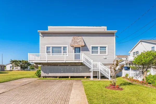 a balcony with table and chairs