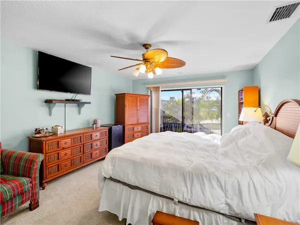 a bedroom with bed and flat screen tv
